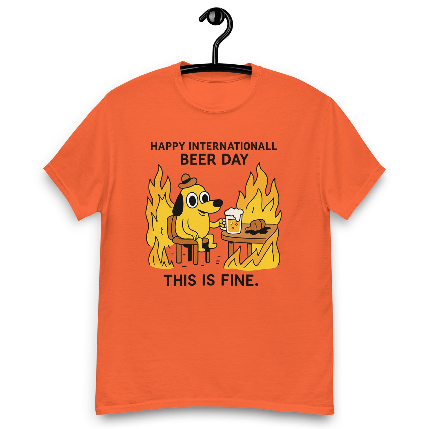 Graphic t-shirt with beer mugs clinking and International Beer Day text, flat lay