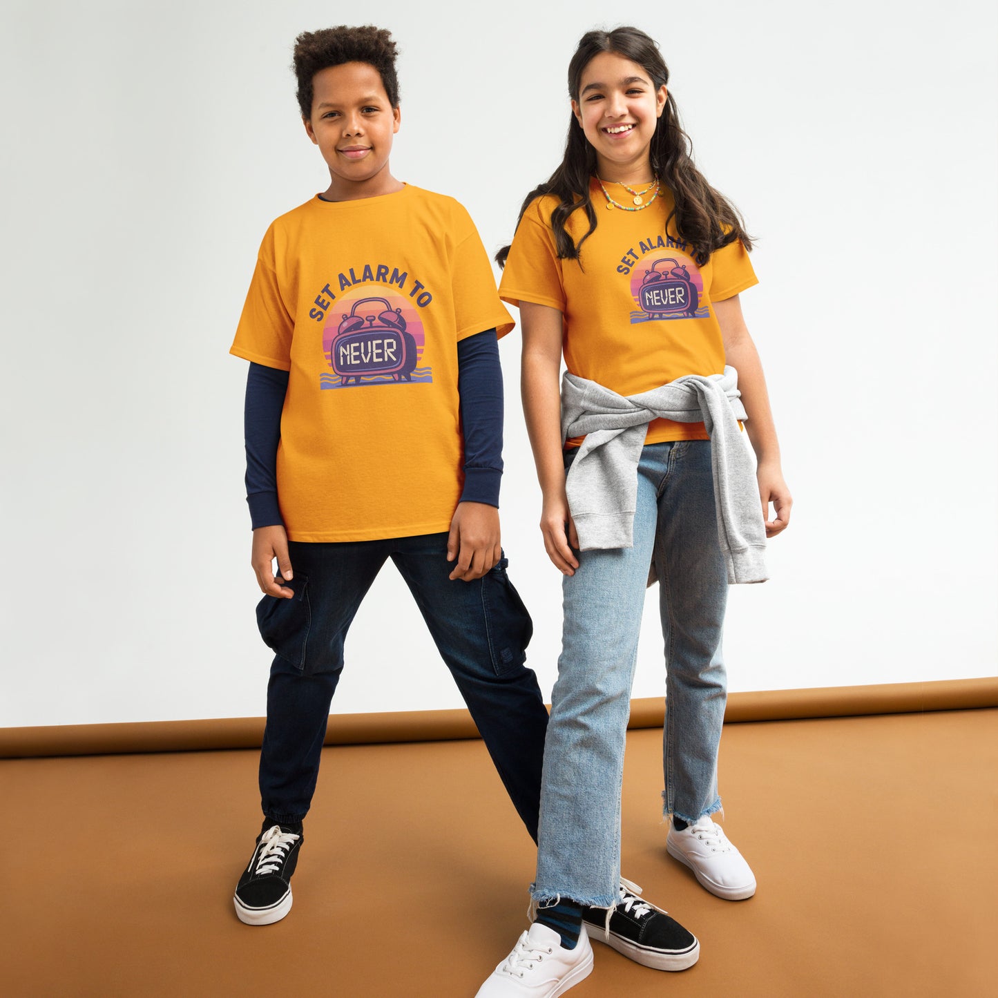 School’s Out t-shirt with bold colorful lettering, flat lay on wooden surface