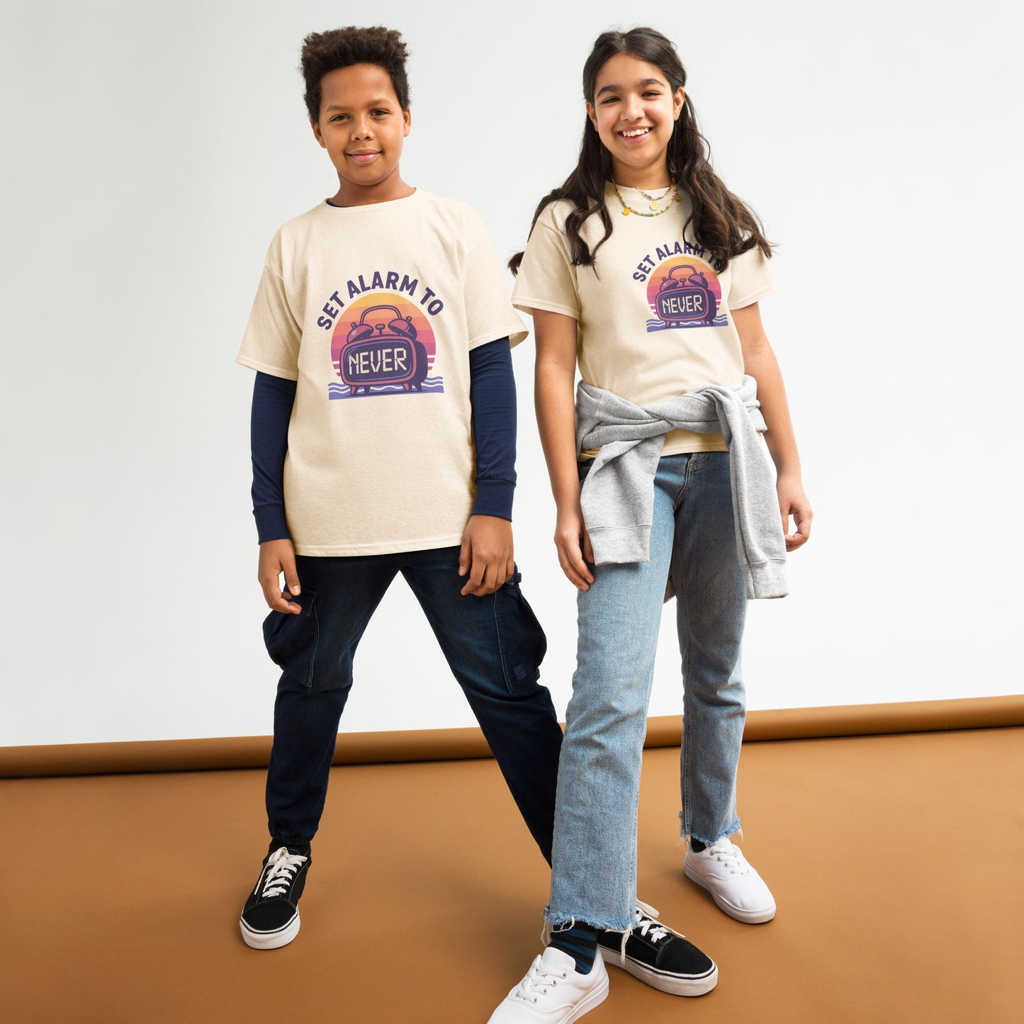School’s Out t-shirt with bold colorful lettering, flat lay on wooden surface