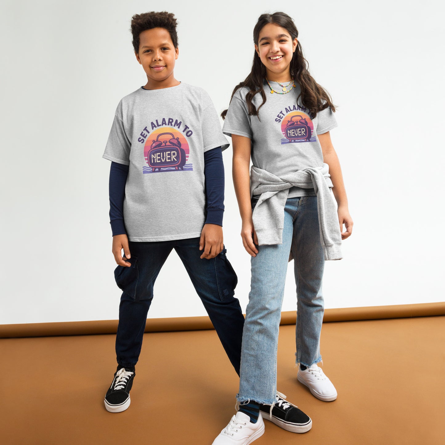 School’s Out t-shirt with bold colorful lettering, flat lay on wooden surface