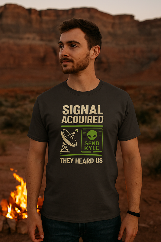 Man wearing a t-shirt with text and graphics in a desert setting with a campfire.
