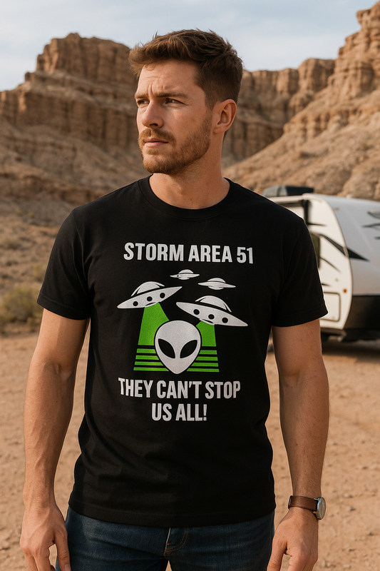 Man wearing a black t-shirt with UFO and alien graphics in a desert setting