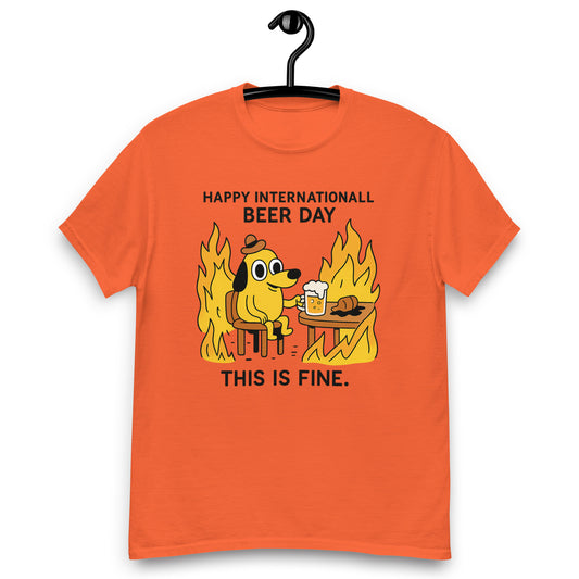 Graphic t-shirt with beer mugs clinking and International Beer Day text, flat lay