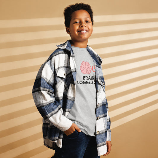 School’s Out t-shirt with bold colorful lettering, flat lay on wooden surface